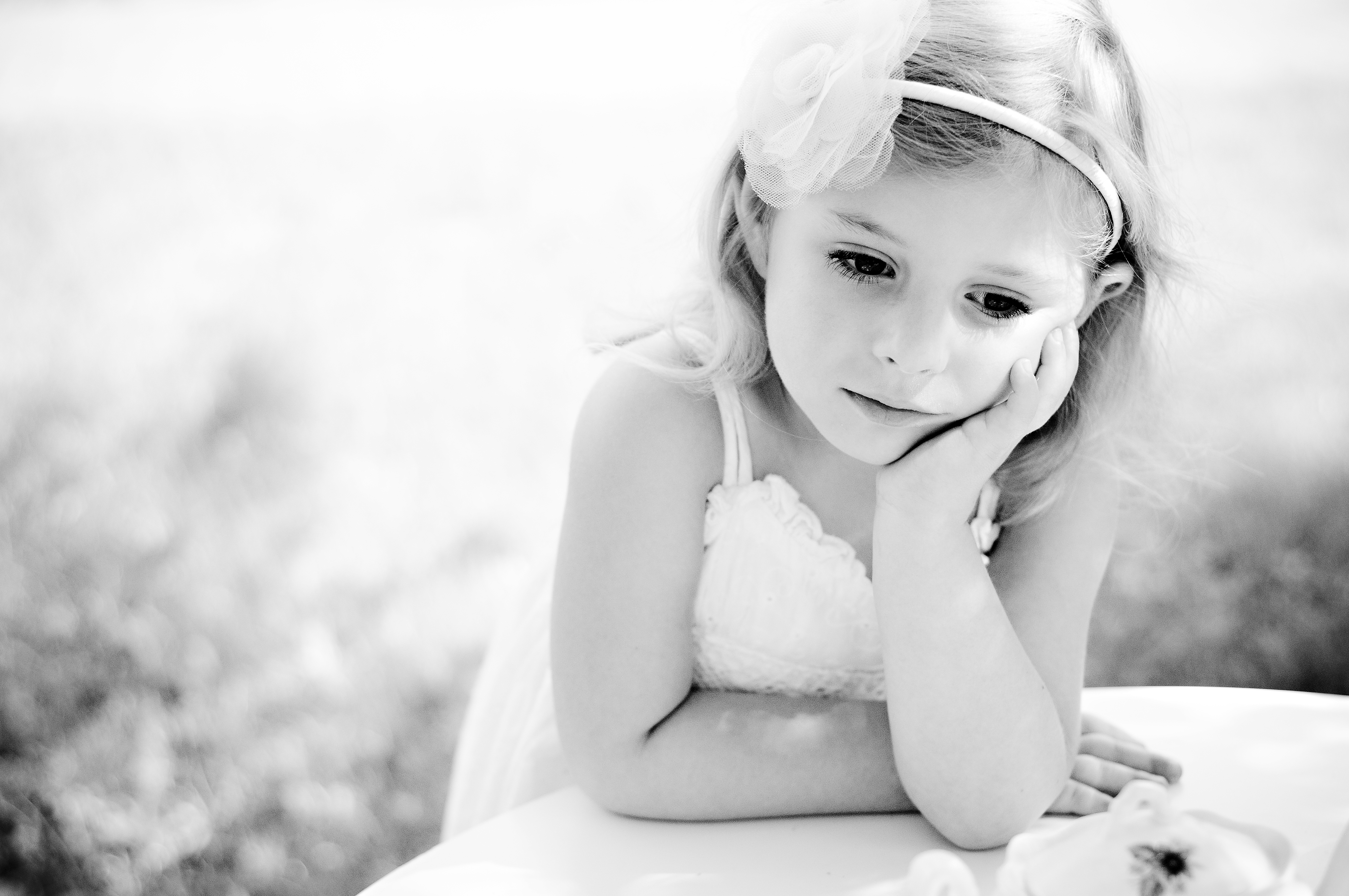 black and white portrait of little girl looking off thinking