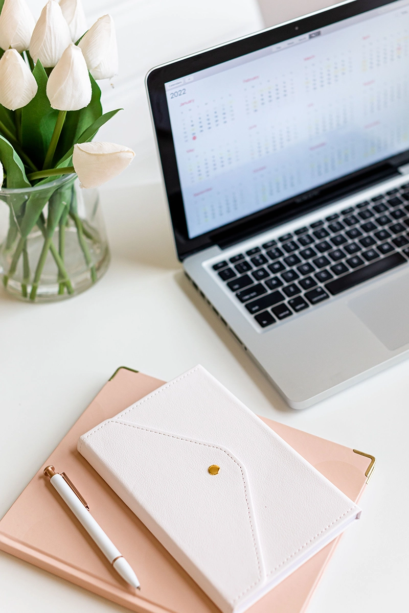 Laptop and notebook laying on desk